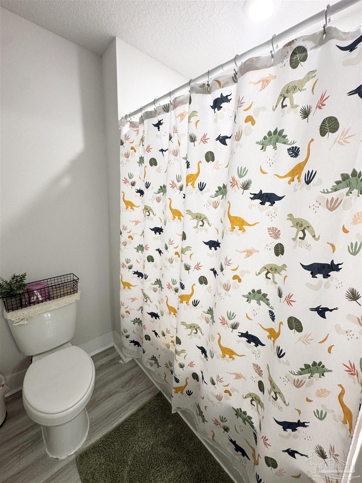 3315 Garganey Road Pace, FL 32571 - Photo 32 of 52 a white toilet sitting next to a shower curtain