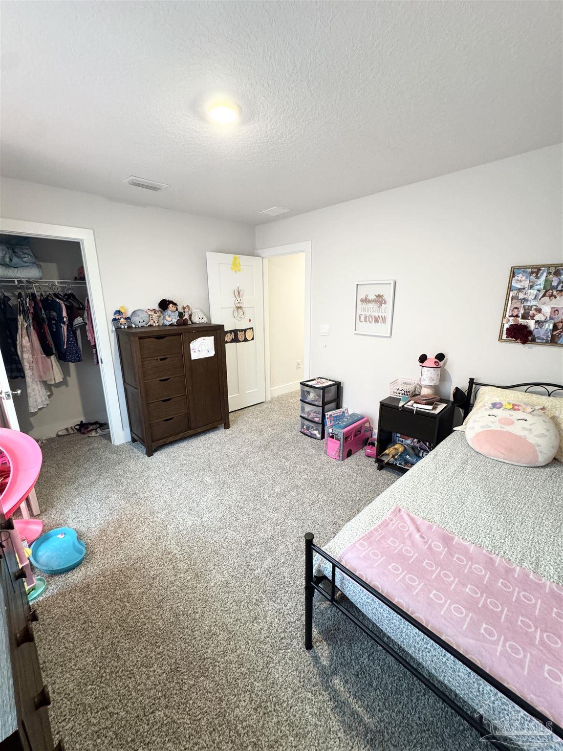 3315 Garganey Road Pace, FL 32571 - Photo 35 of 52 a bedroom with furniture and a bed