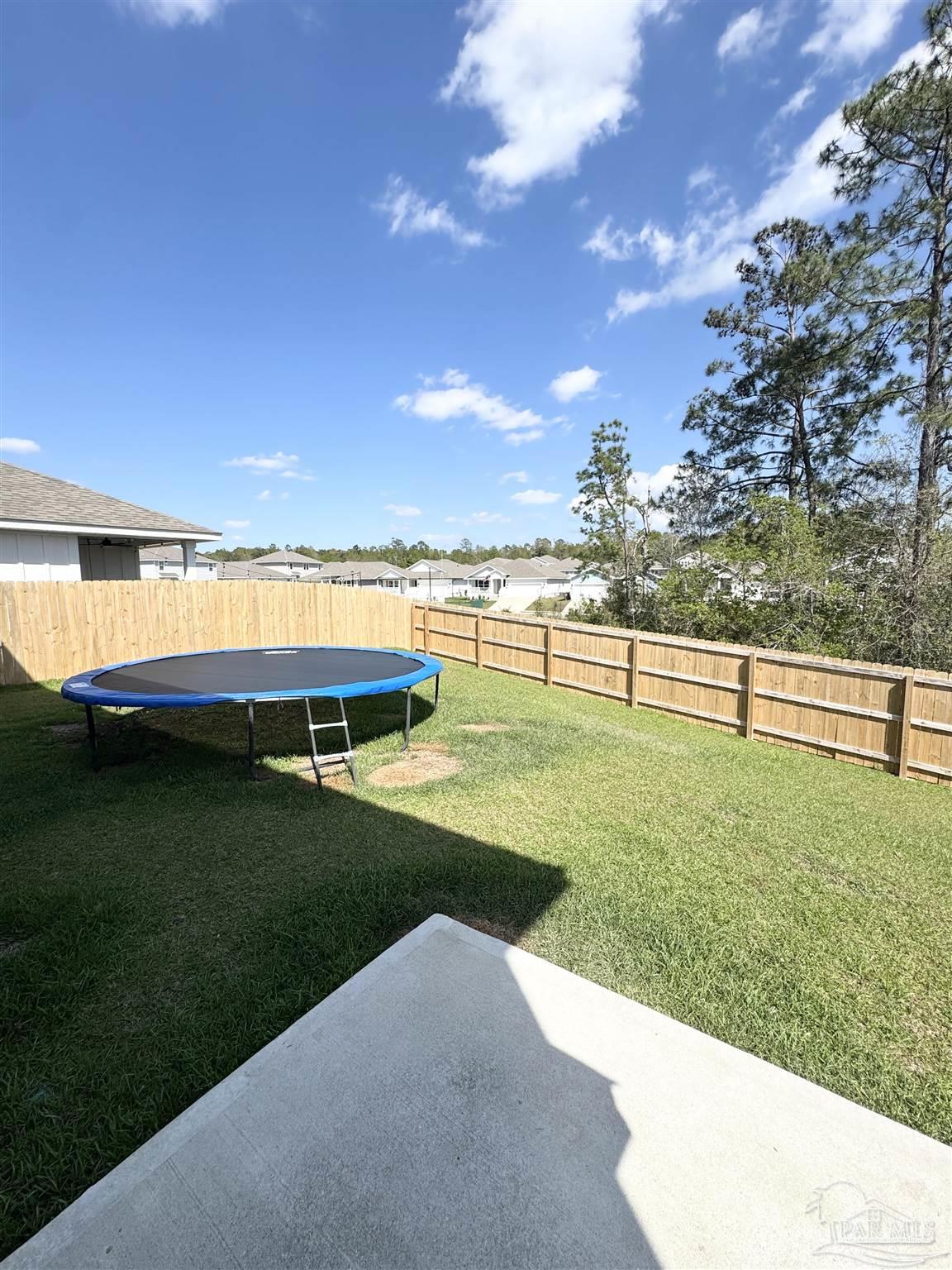 3315 Garganey Road Pace, FL 32571 - Photo 38 of 52 a view of a swimming pool with an outdoor space and seating area