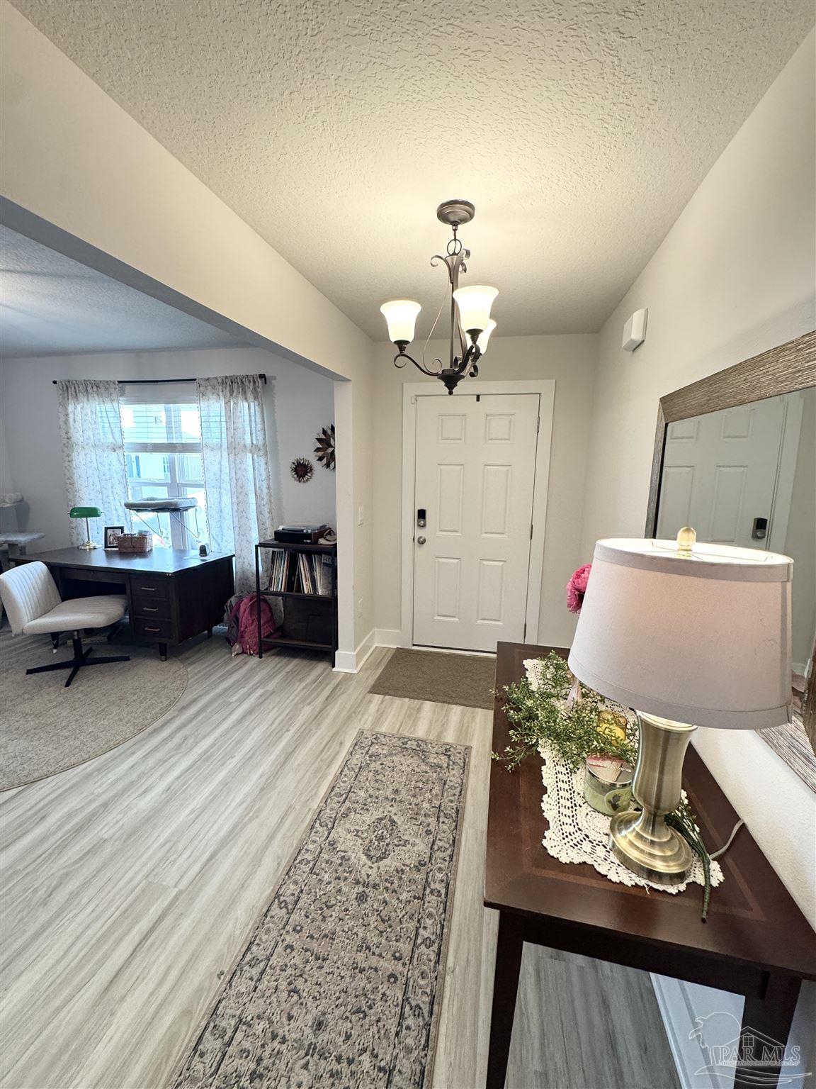 3315 Garganey Road Pace, FL 32571 - Photo 4 of 52 a living room with furniture and a fireplace