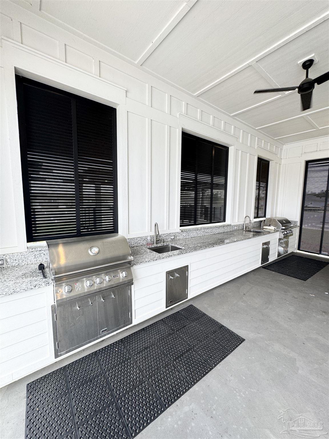 3315 Garganey Road Pace, FL 32571 - Photo 50 of 52 a view of a kitchen with granite countertop a sink and a stove top oven