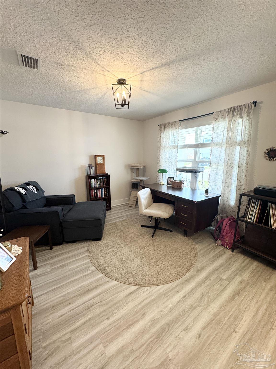 3315 Garganey Road Pace, FL 32571 - Photo 5 of 52 a living room with furniture and a flat screen tv