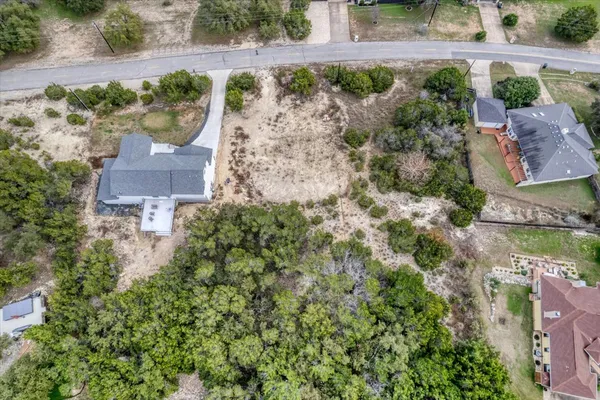 an aerial view of a house with a yard and garden
