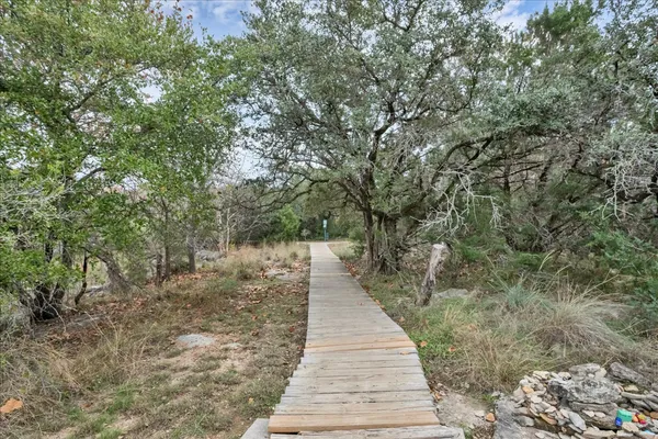 a view of a pathway with a wrought fence