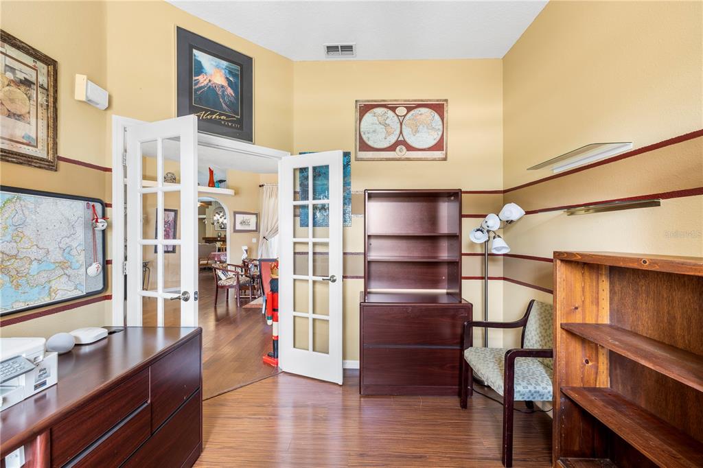 3051 Waterfall Drive Spring Hill, FL 34608 - Photo 11 of 74 a view of a hallway with wooden floor and furniture