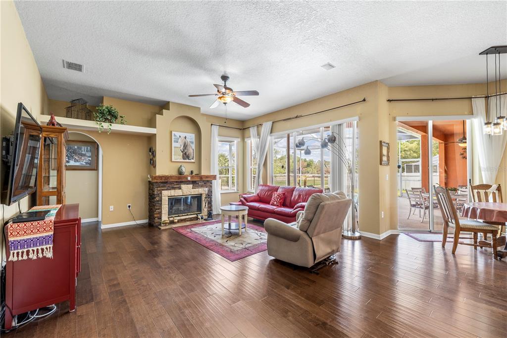 3051 Waterfall Drive Spring Hill, FL 34608 - Photo 17 of 74 a living room with furniture a wooden floor and a large window