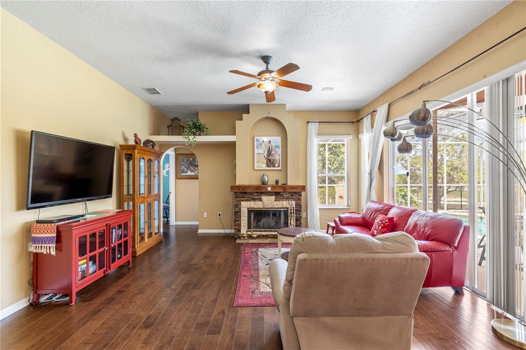 3051 Waterfall Drive Spring Hill, FL 34608 - Photo 18 of 74 a living room with furniture and a flat screen tv