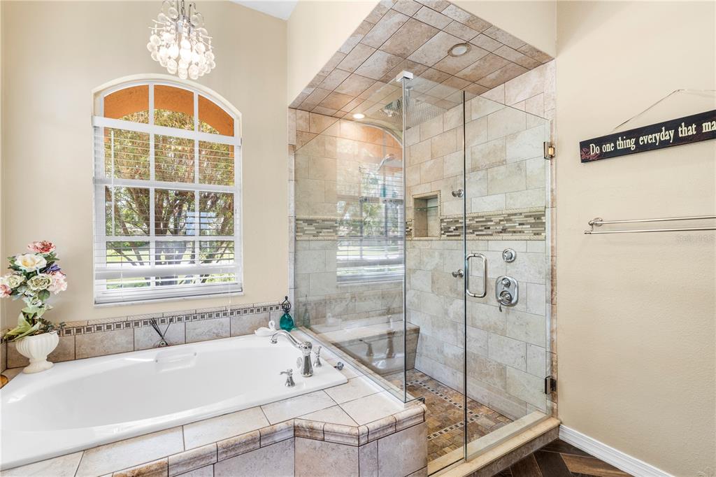 3051 Waterfall Drive Spring Hill, FL 34608 - Photo 23 of 74 a bathroom with a tub and a shower
