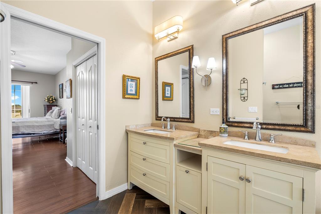 3051 Waterfall Drive Spring Hill, FL 34608 - Photo 24 of 74 a en suite bathroom with a double vanity sink a mirror and a shower