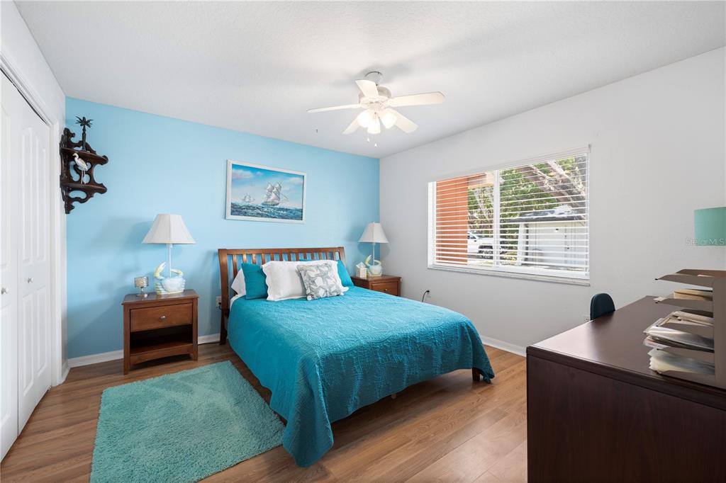 3051 Waterfall Drive Spring Hill, FL 34608 - Photo 27 of 74 a bedroom with a bed and a chandelier