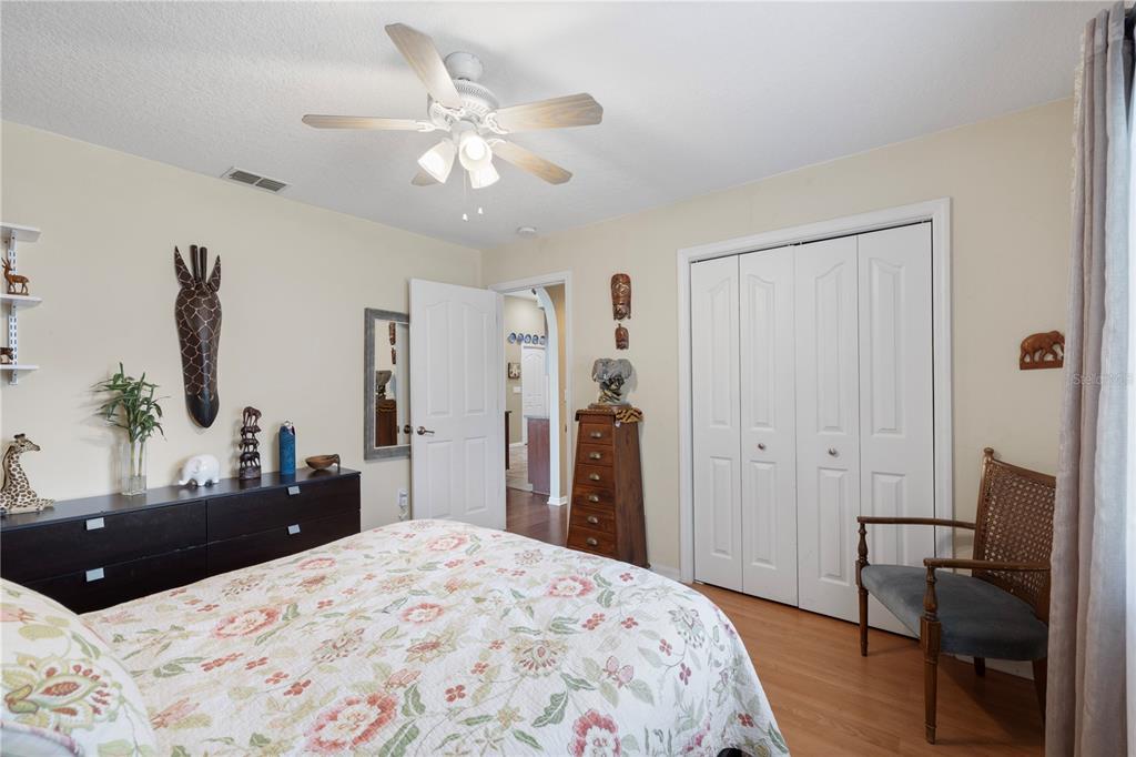 3051 Waterfall Drive Spring Hill, FL 34608 - Photo 31 of 74 a bedroom with a bed and a chandelier