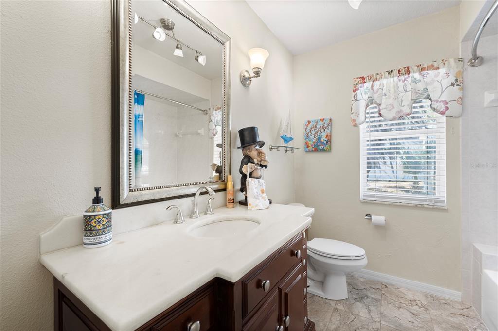 3051 Waterfall Drive Spring Hill, FL 34608 - Photo 32 of 74 a bathroom with a sink vanity and a toilet