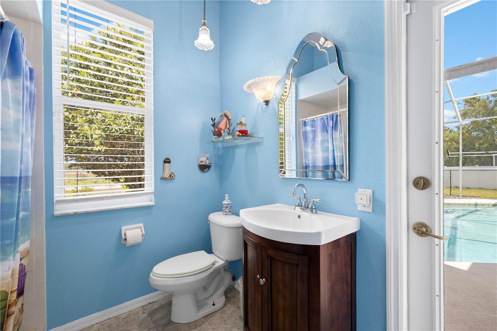 3051 Waterfall Drive Spring Hill, FL 34608 - Photo 38 of 74 a bathroom with a sink toilet and a mirror