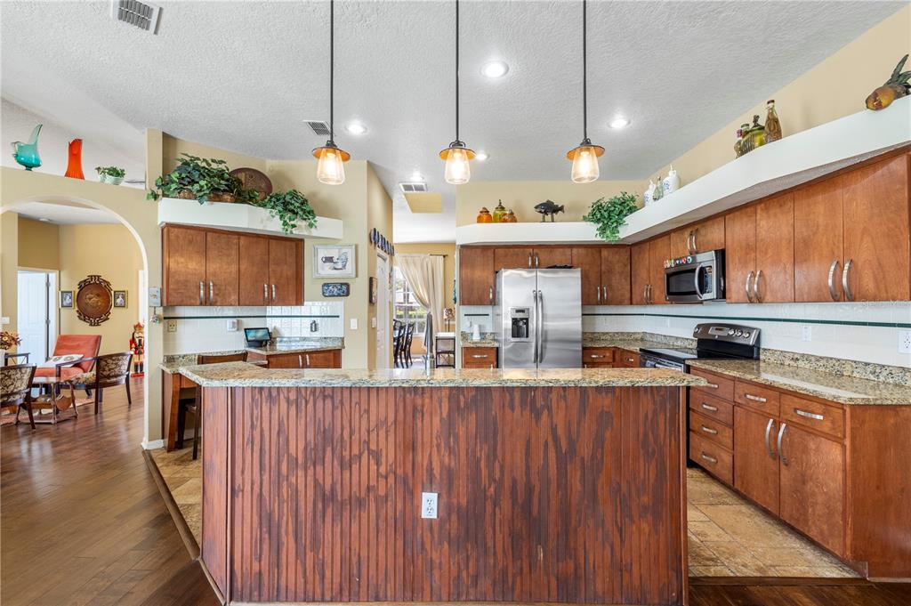 3051 Waterfall Drive Spring Hill, FL 34608 - Photo 61 of 74 a kitchen with lots of counter space and wooden floor