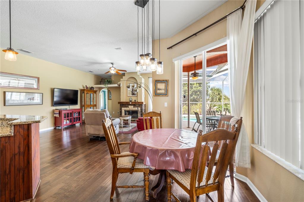 3051 Waterfall Drive Spring Hill, FL 34608 - Photo 63 of 74 a view of a dining room with furniture window and wooden floor