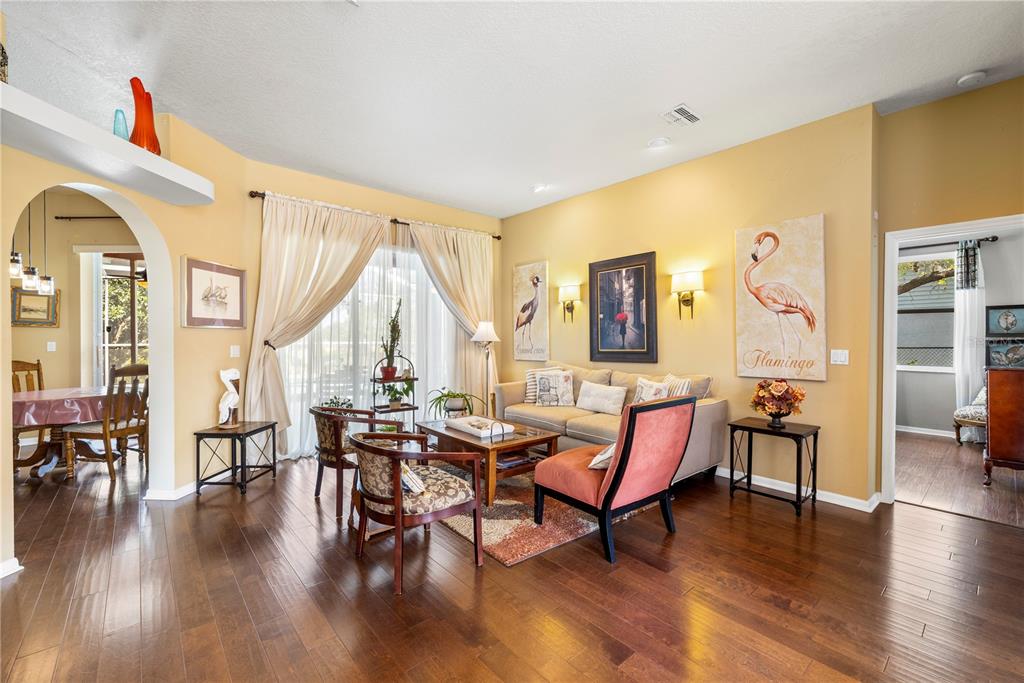 3051 Waterfall Drive Spring Hill, FL 34608 - Photo 64 of 74 a living room with furniture a wooden floor and a large window