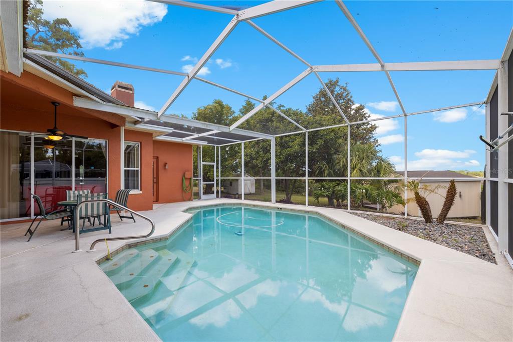 3051 Waterfall Drive Spring Hill, FL 34608 - Photo 65 of 74 a view of a swimming pool with a lounge chair