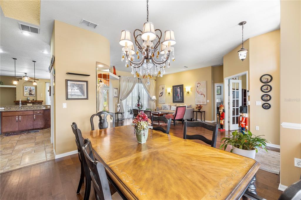 3051 Waterfall Drive Spring Hill, FL 34608 - Photo 8 of 74 a view of a dining room with furniture and wooden floor