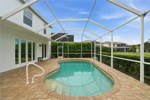 a view of a white house with swimming pool