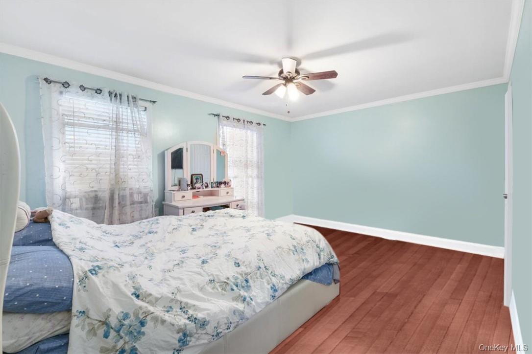 2 Soundview Avenue, Unit 2D White Plains, NY 10606 - Photo 13 of 16 a bedroom with a large bed and wooden floor