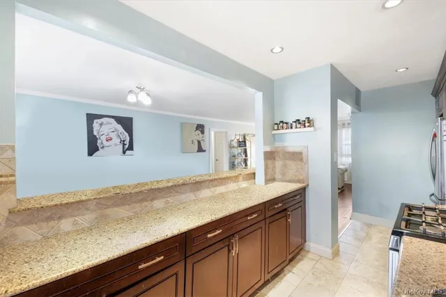 a view of a kitchen with stainless steel appliances granite countertop a refrigerator and a sink