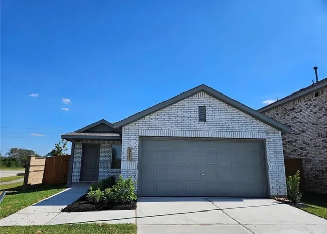a front view of a house with garage