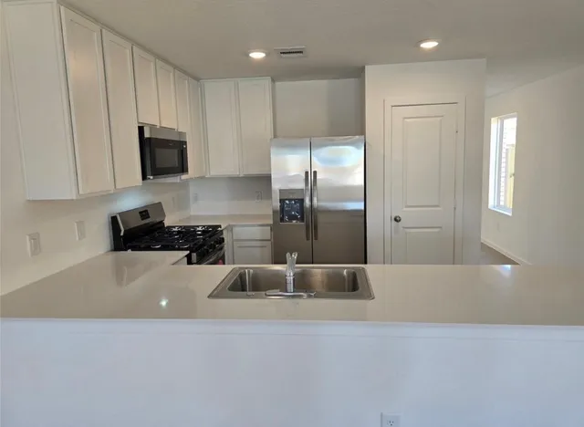 a bathroom with a tub a sink and a mirror