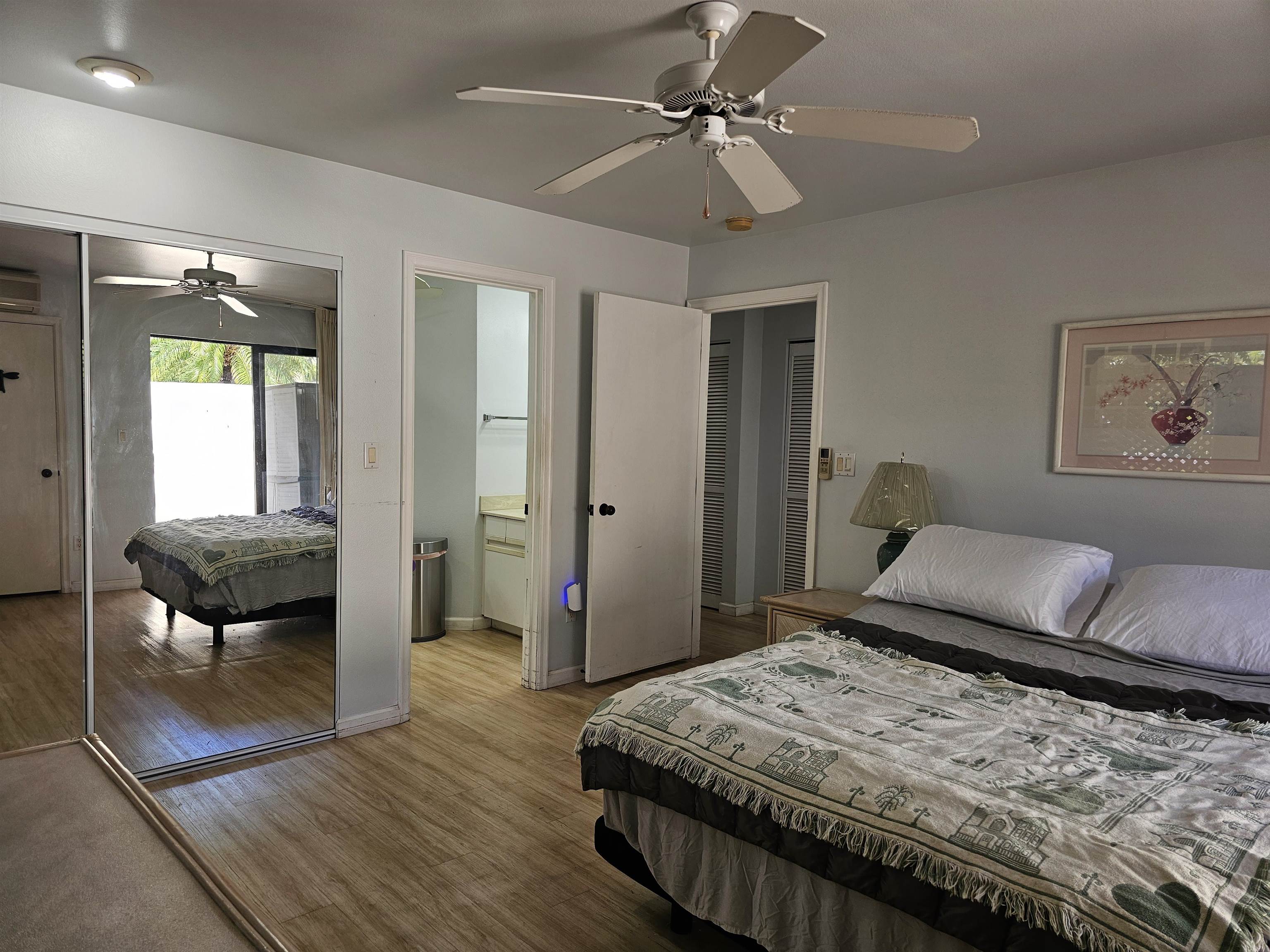 2777 South Kihei Road, Unit K107 Kihei, HI 96753 - Photo 34 of 50 a bedroom with a bed and a chandelier
