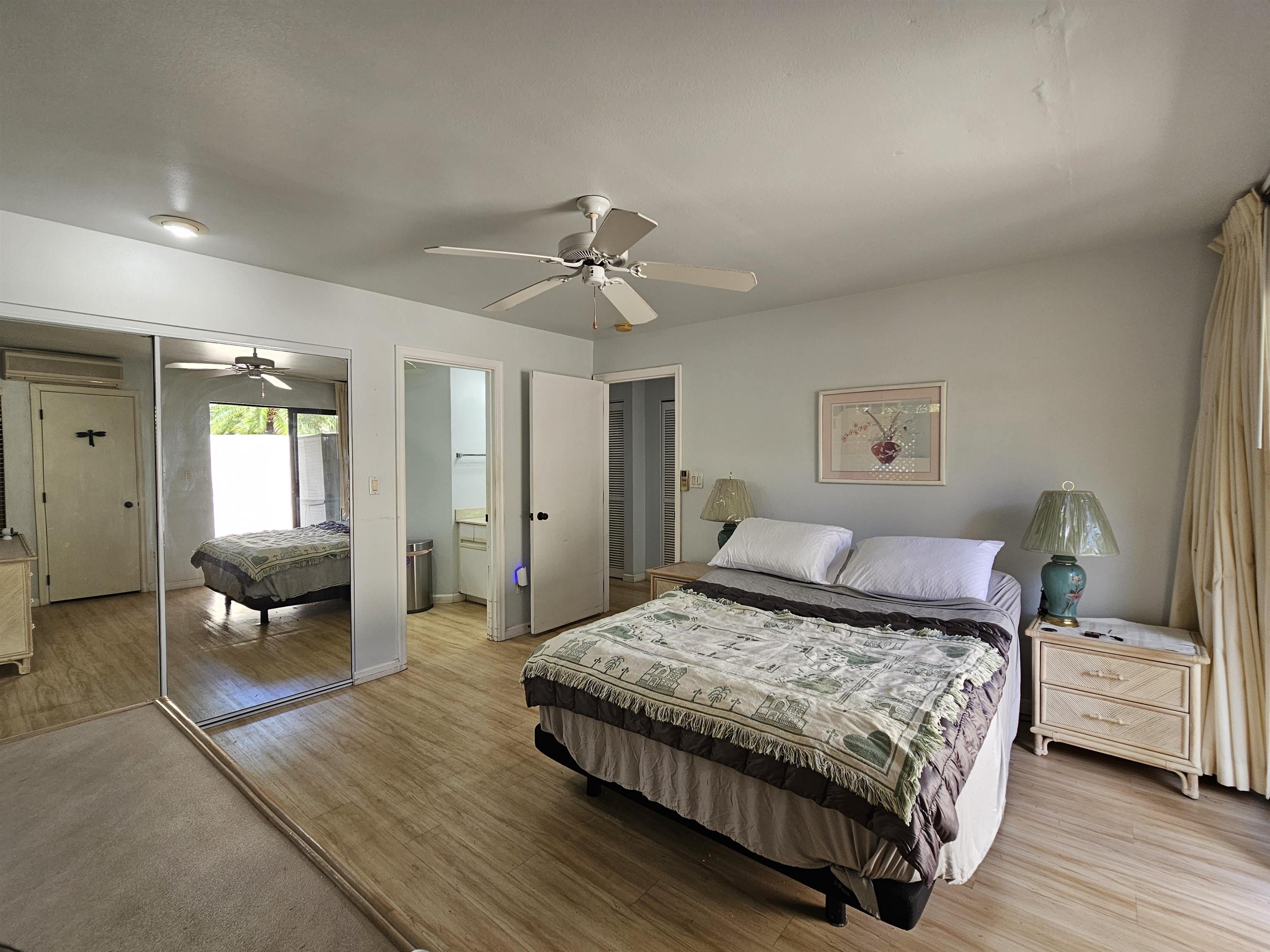 2777 South Kihei Road, Unit K107 Kihei, HI 96753 - Photo 38 of 50 a bedroom with a large bed a couch and potted plant