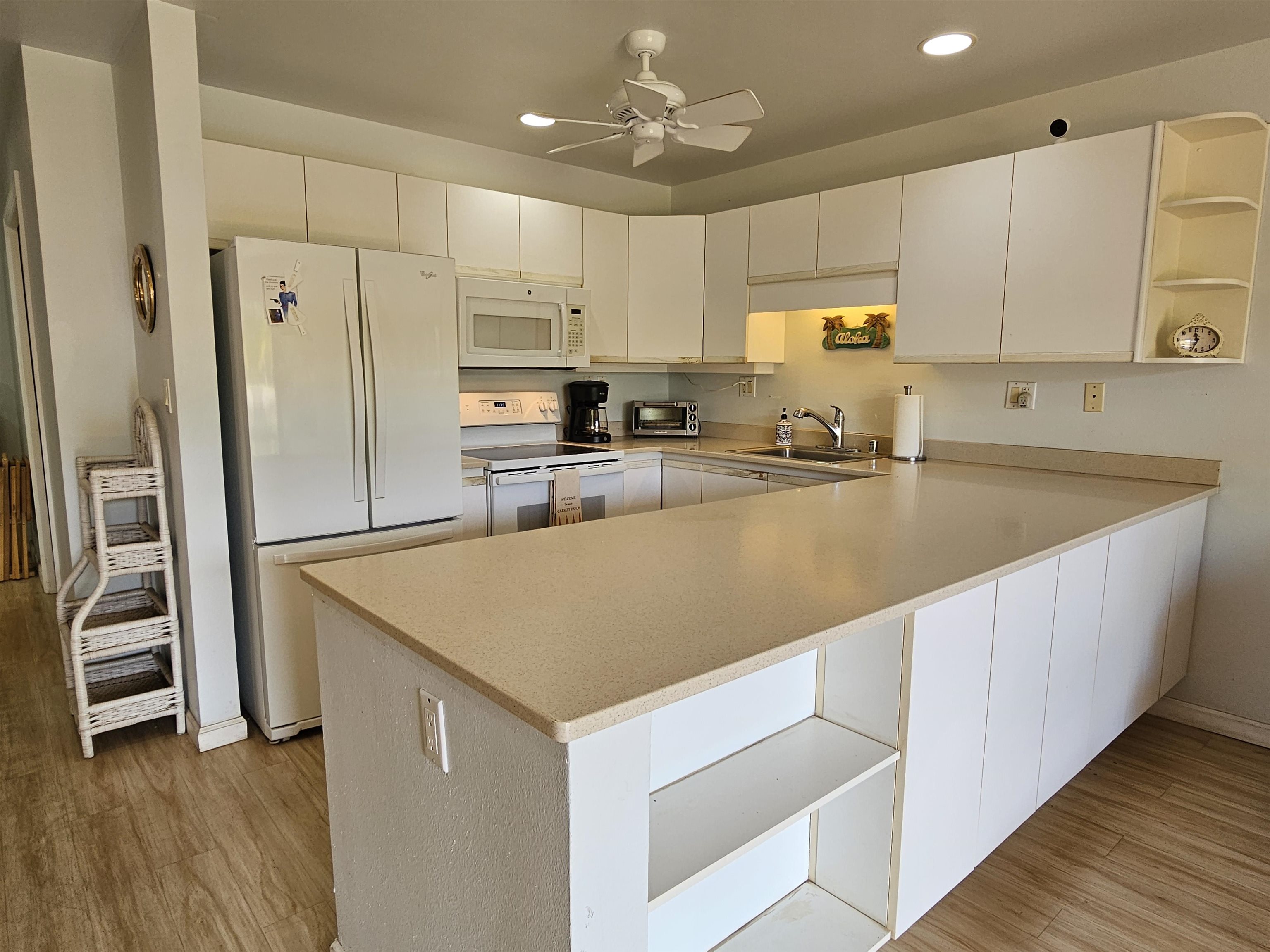 2777 South Kihei Road, Unit K107 Kihei, HI 96753 - Photo 4 of 50 a kitchen with stainless steel appliances a refrigerator sink and white cabinets