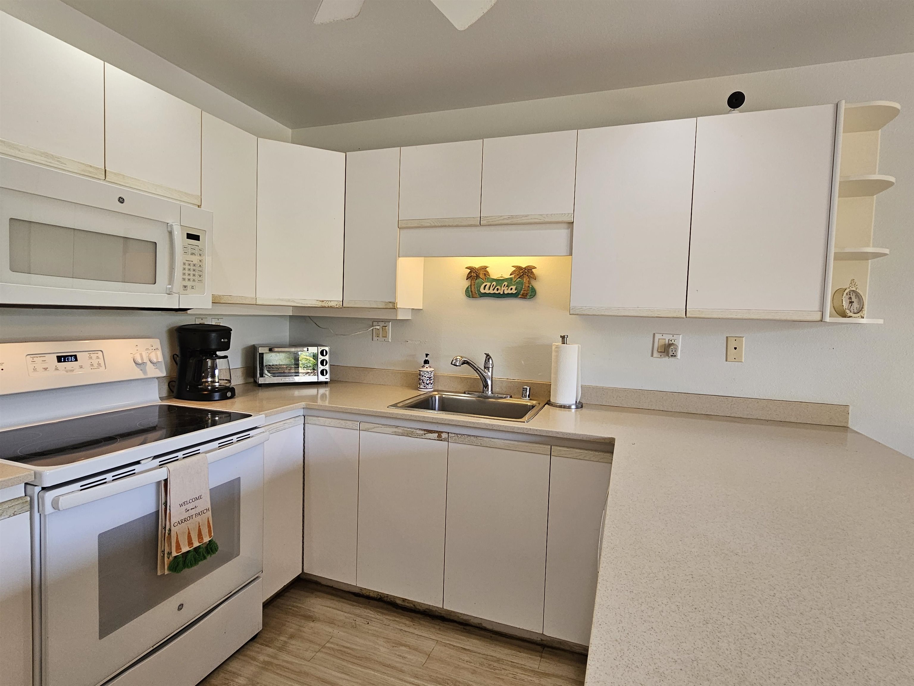 2777 South Kihei Road, Unit K107 Kihei, HI 96753 - Photo 5 of 50 a kitchen with cabinets appliances a sink and a counter top