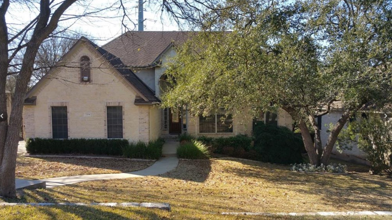 2204 Real Catorce Austin, TX 78746 - Photo 1 of 1 a view of a white house next to a yard with a large tree