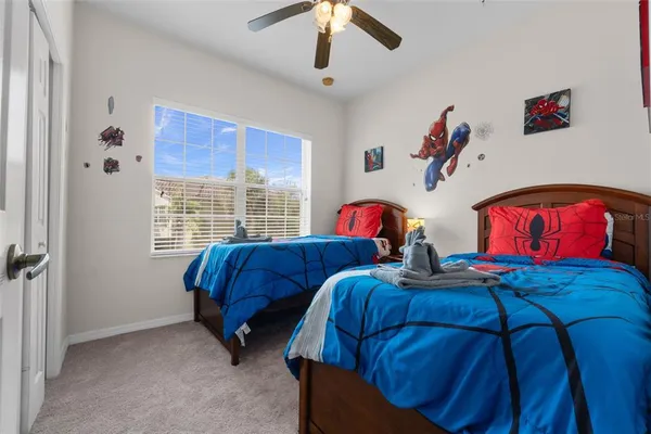 a bedroom with two beds and a window