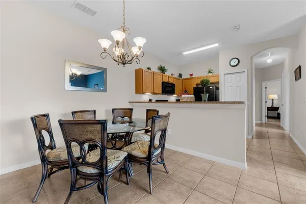 a view of a dining room with furniture and chandelier