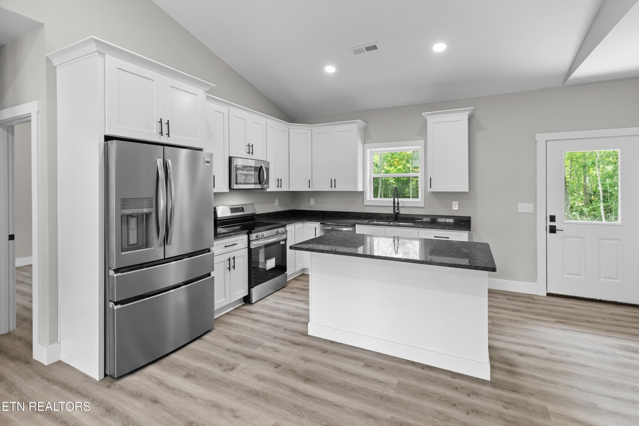 146 Fancher Road Newport, TN 37821 - Photo 8 of 41 a kitchen with stainless steel appliances granite countertop a refrigerator a stove a sink and a microwave