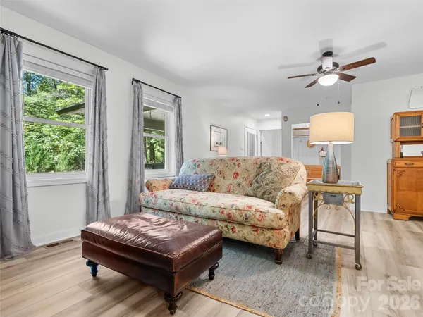 a living room with a bed furniture and a window