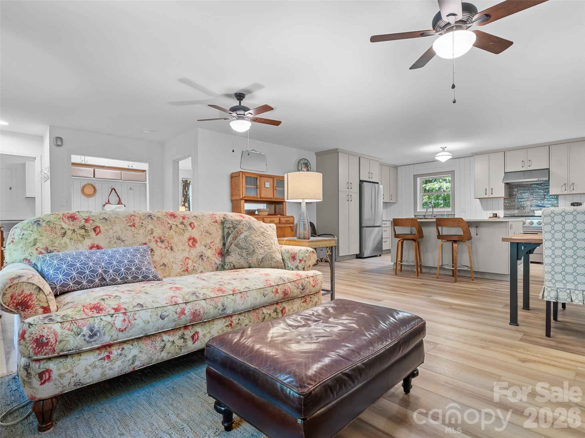 1756 Happy Acres Road Brevard, NC 28712 - Photo 12 of 35 a living room with furniture and a chandelier