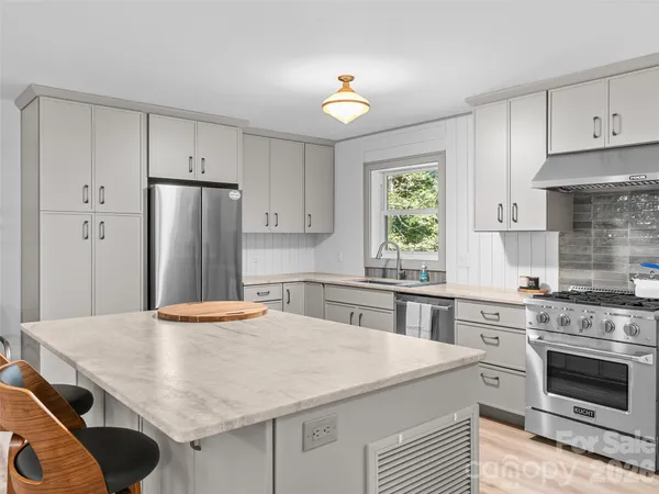 a kitchen with a stove a refrigerator and a stove