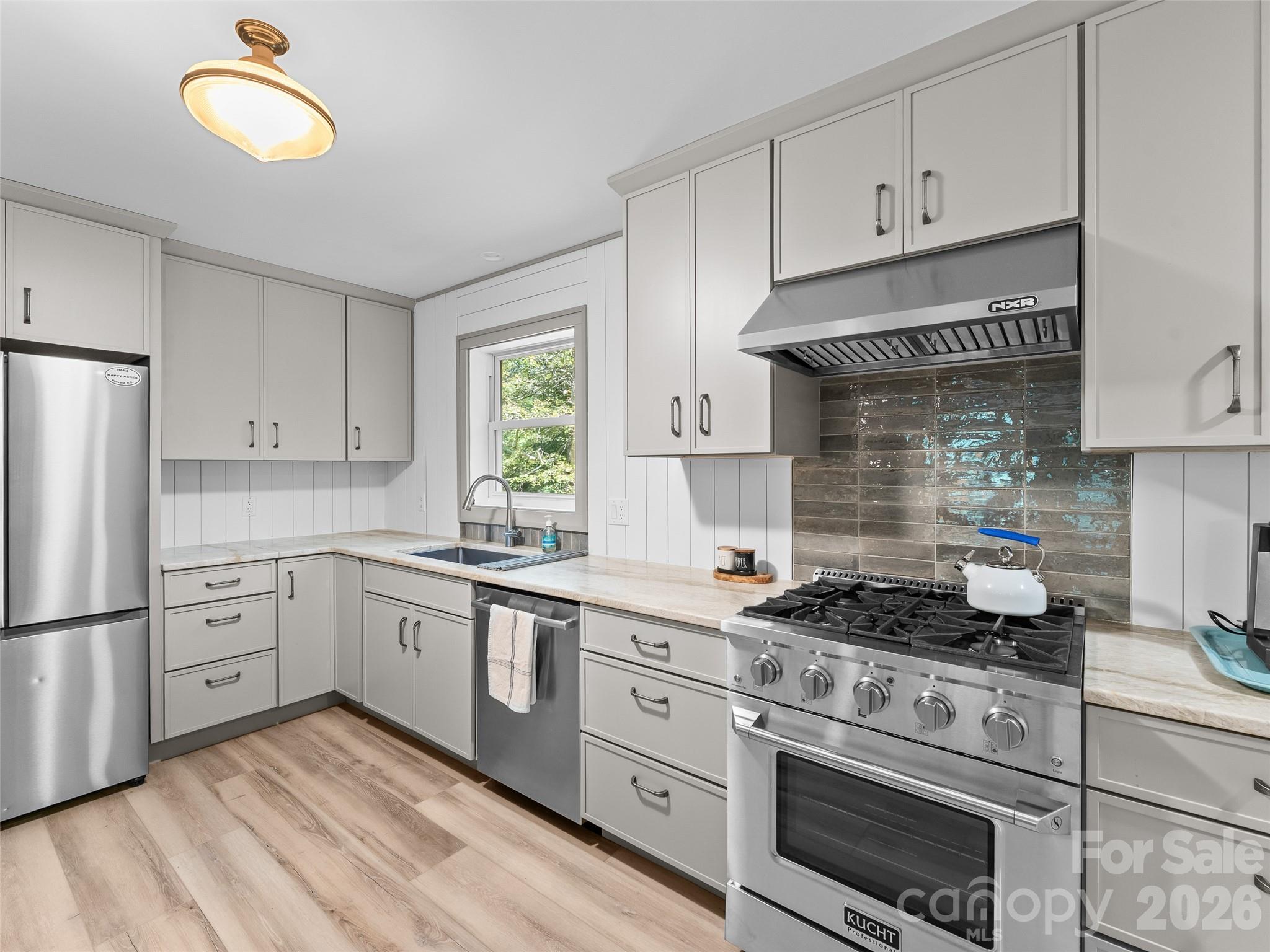 1756 Happy Acres Road Brevard, NC 28712 - Photo 20 of 35 a kitchen with cabinets stainless steel appliances and a window