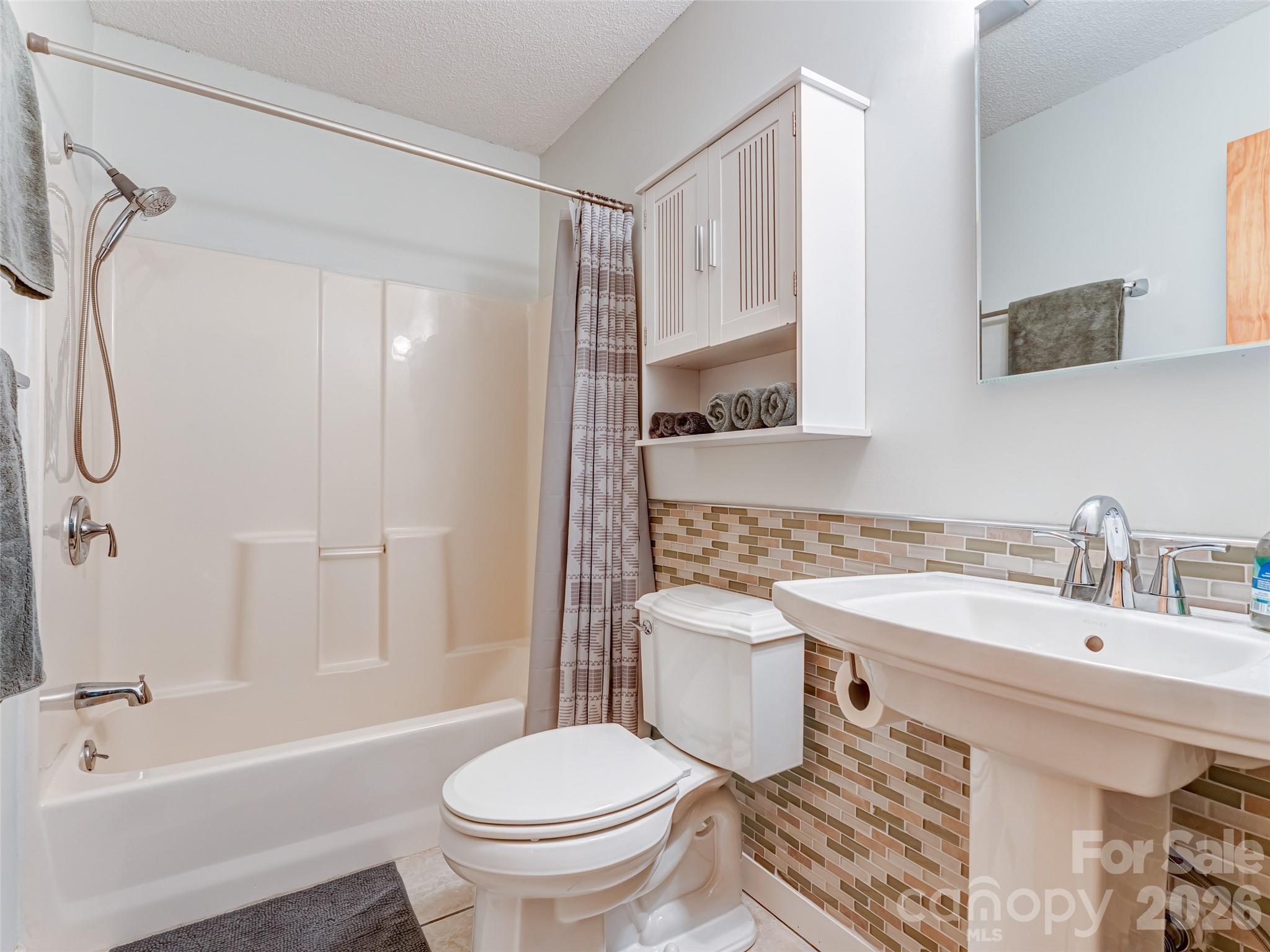 1756 Happy Acres Road Brevard, NC 28712 - Photo 21 of 35 a bathroom with a sink toilet and shower