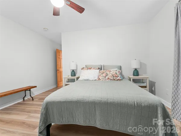 a bedroom with a bed and a chandelier