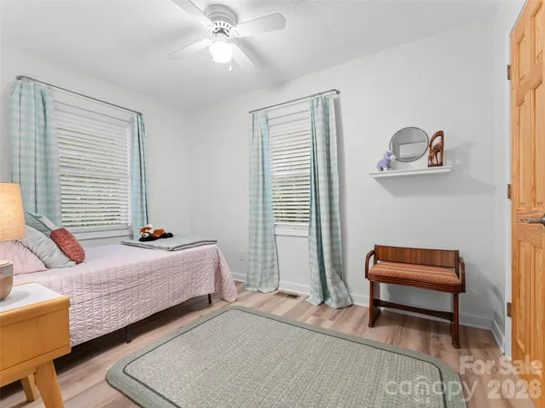 a bedroom with bed and a window