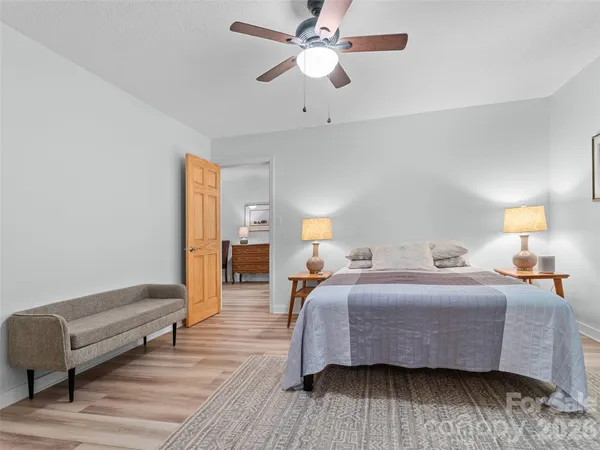 a bedroom with a bed and wooden floor