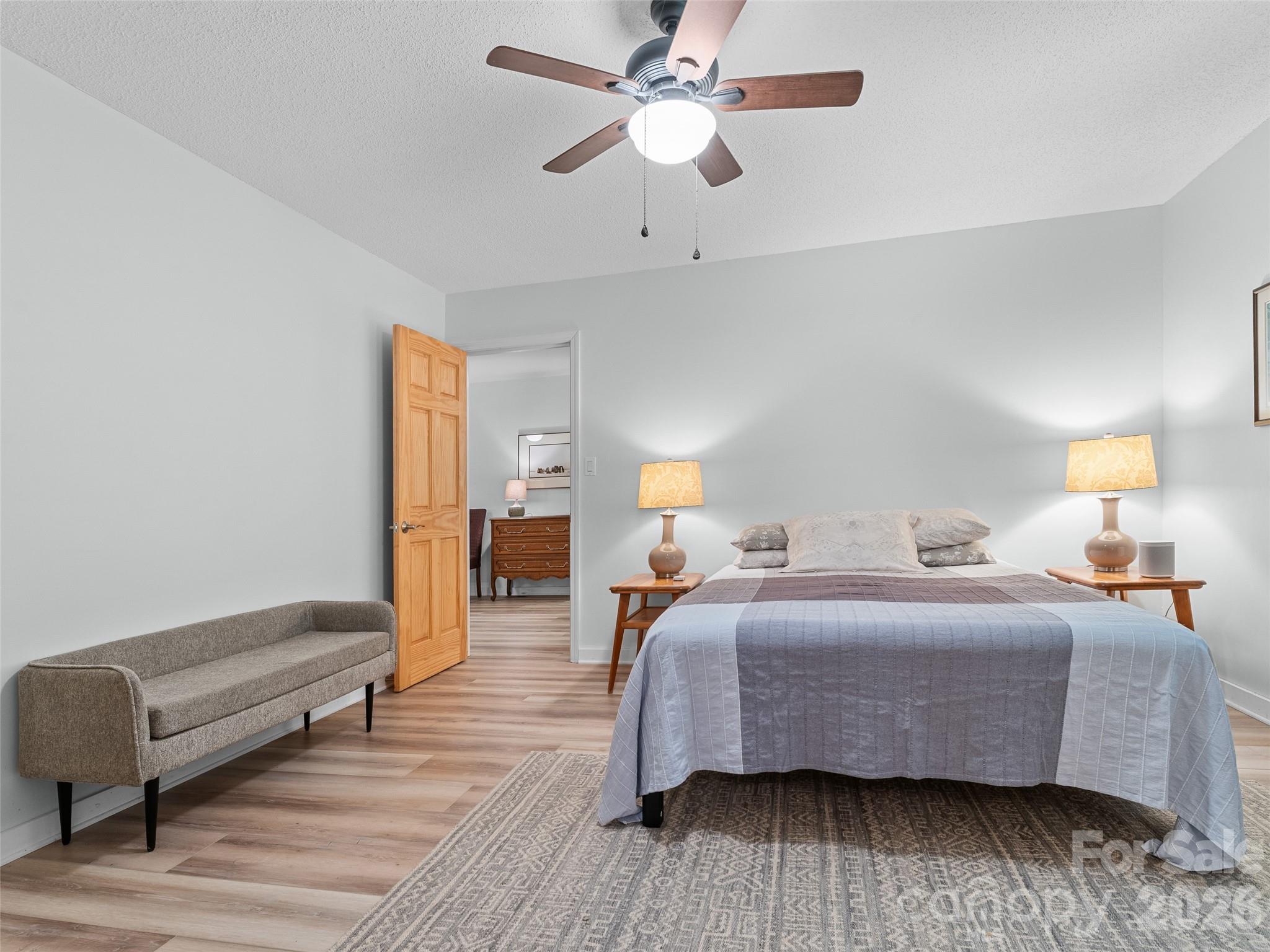 1756 Happy Acres Road Brevard, NC 28712 - Photo 27 of 35 a bedroom with a bed and wooden floor