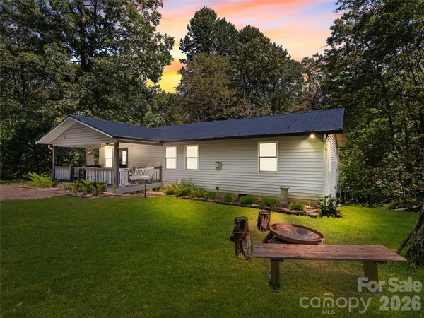 a backyard of a house with table and chairs