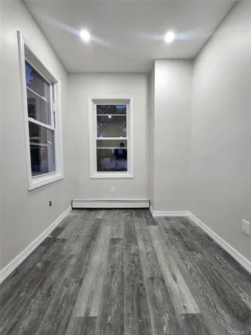 a bathroom with a toilet a sink a shower and mirror