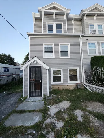 a view of a brick house with many windows
