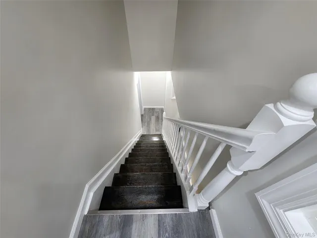 a view of a hallway with a livingroom and a bathroom