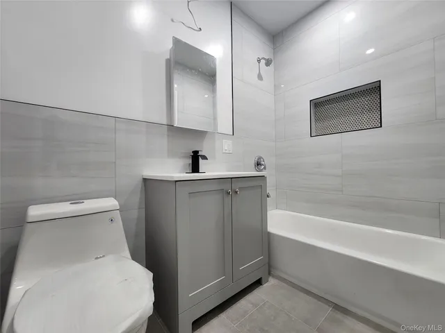 a bathroom with a sink a toilet and bathtub