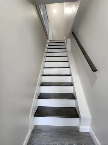 a kitchen with granite countertop a refrigerator and a stove top oven